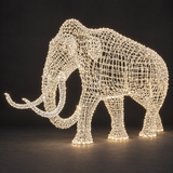 Mammoth Sculpture — illuminated sculpture with beaded mini lights, dark studio view