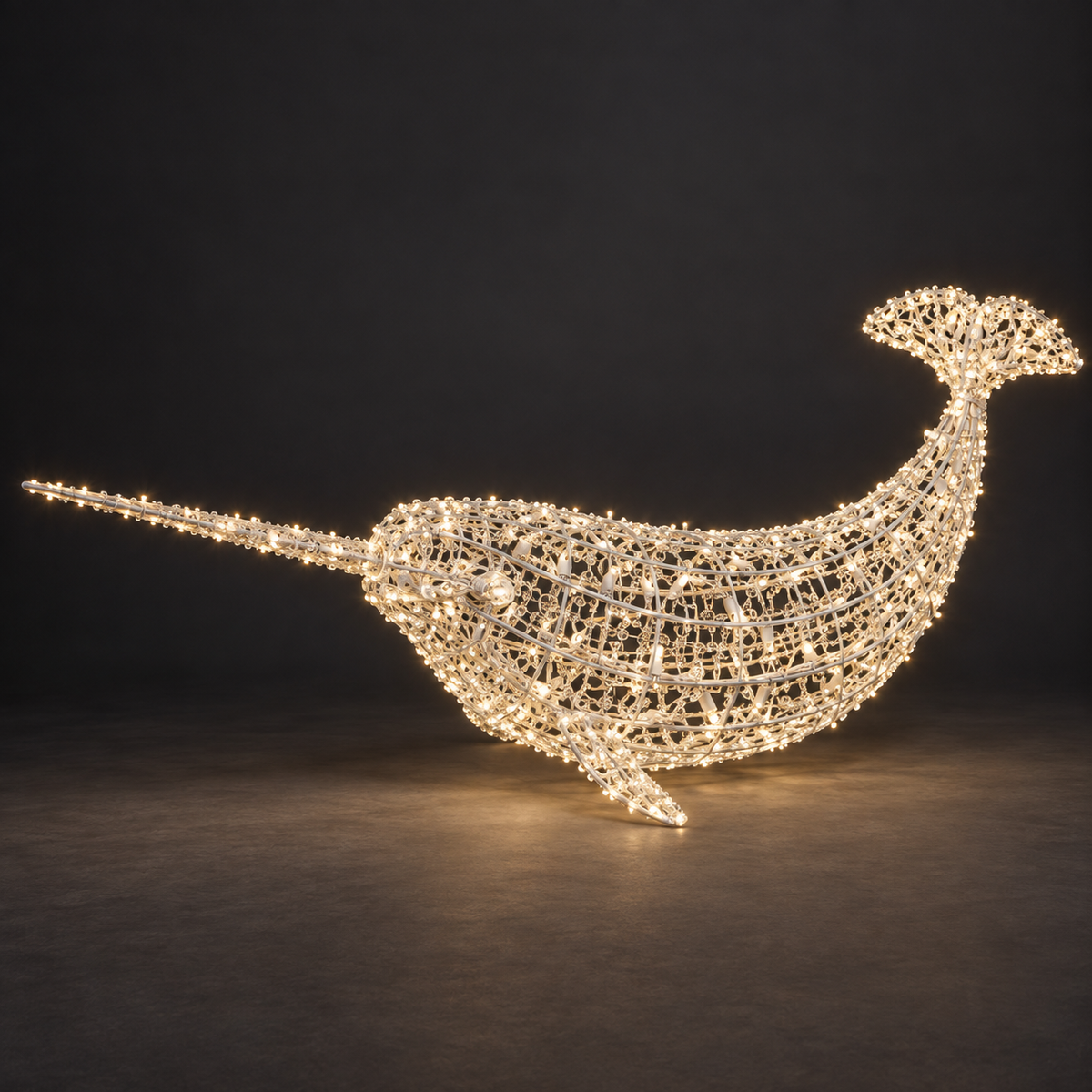 Narwhal Sculpture — illuminated sculpture with beaded mini lights, dark studio view